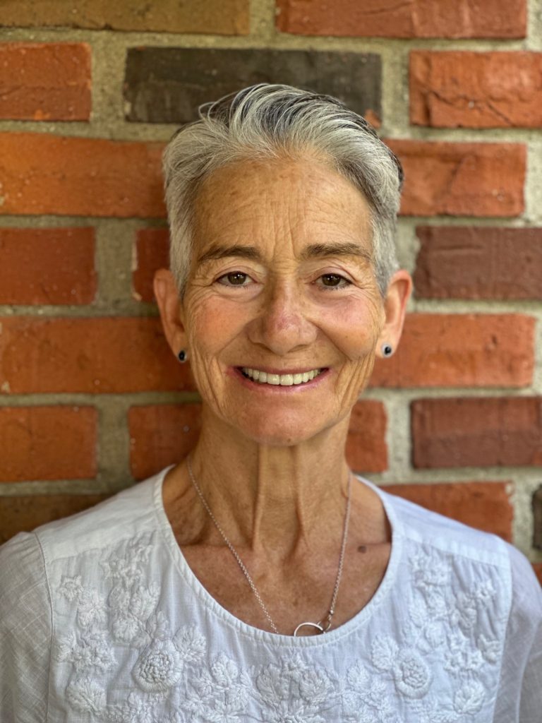 Julee Waldrop stands in front of brick wall