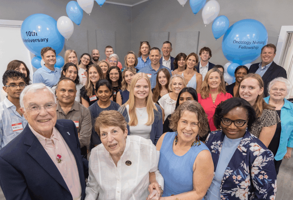 Oncology Fellowship program donors, faculty, students and family all stand together under a balloon arch