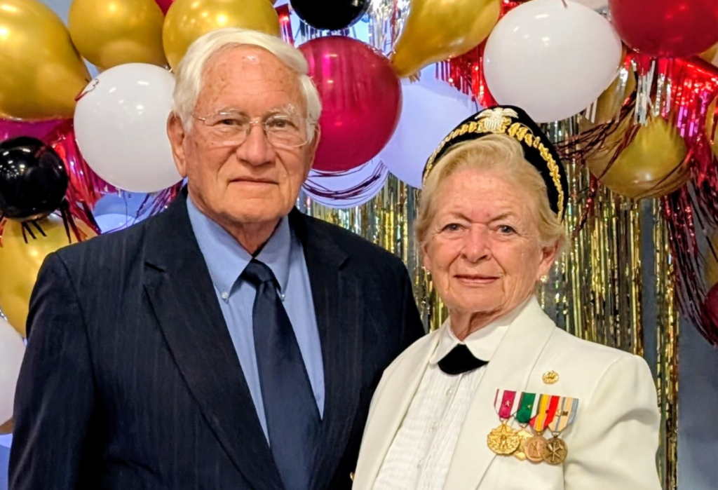 Jo-Anne and Ted Martin post in front of balloons
